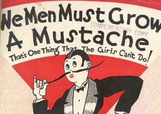 A cartoon image of a person with a long moustache that reads 'we men must grow a mustache, that's one thing that the girls can't do'