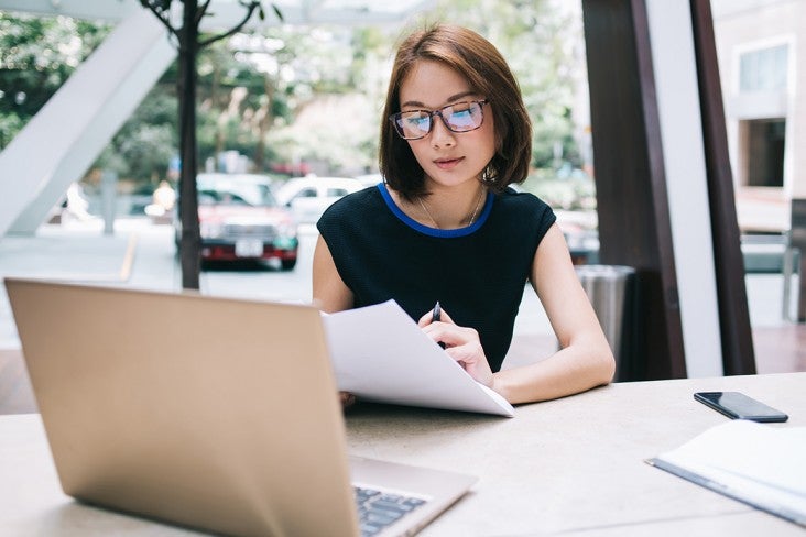 A person at a desk reading 